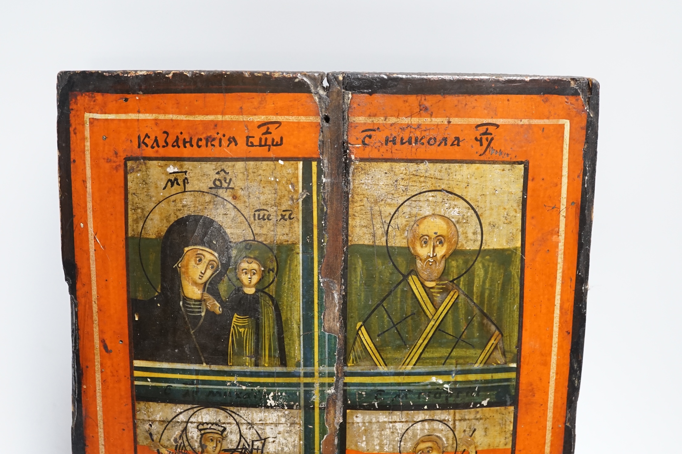 A quadripartite Russian Icon of the Virgin and Child, St. Nicholas, St. Demetrius and St. George, 27 x 22cm
